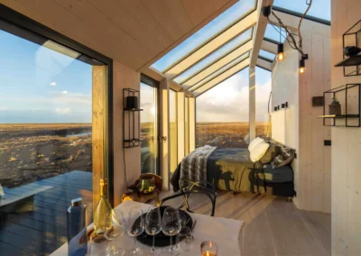 Blár, Hella, a glass house in Iceland with a hot tub and the northern lights as a roof.